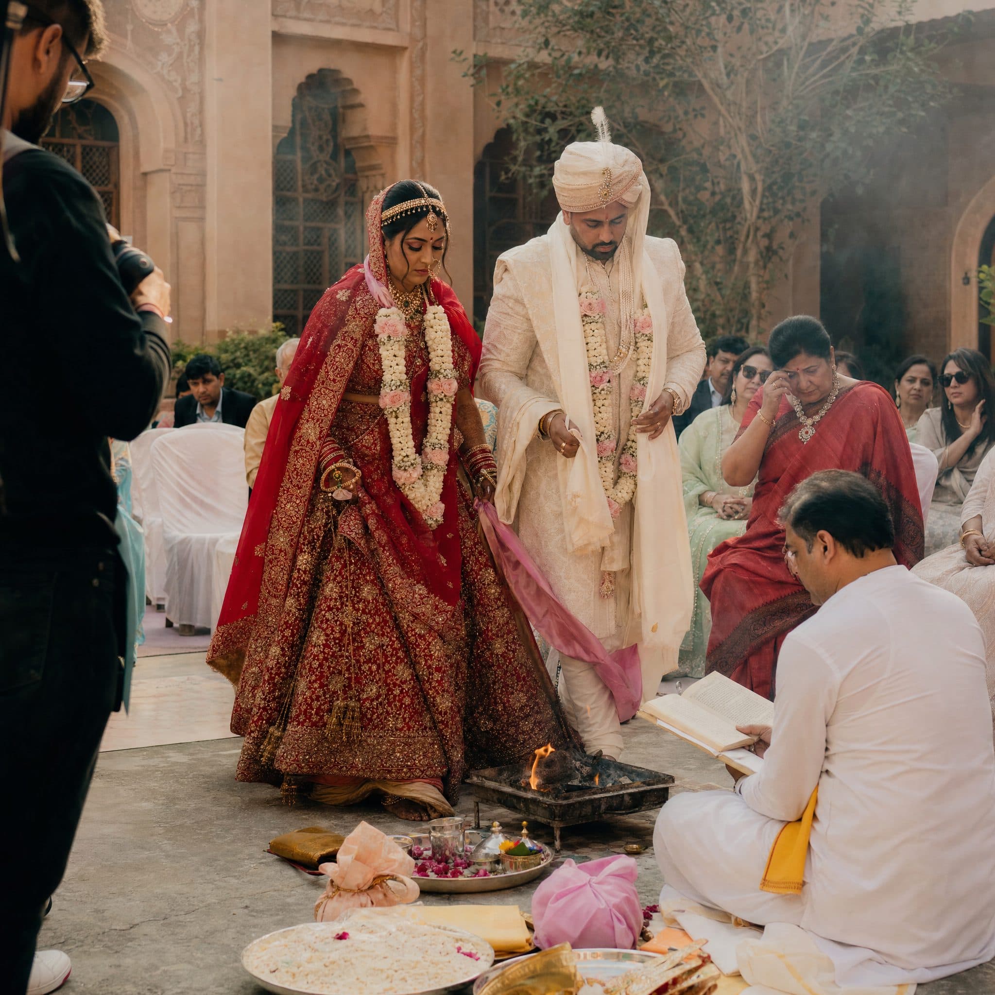 Bride and groom circling the sacred fire during the Pheras ceremony at a Marrakech palace